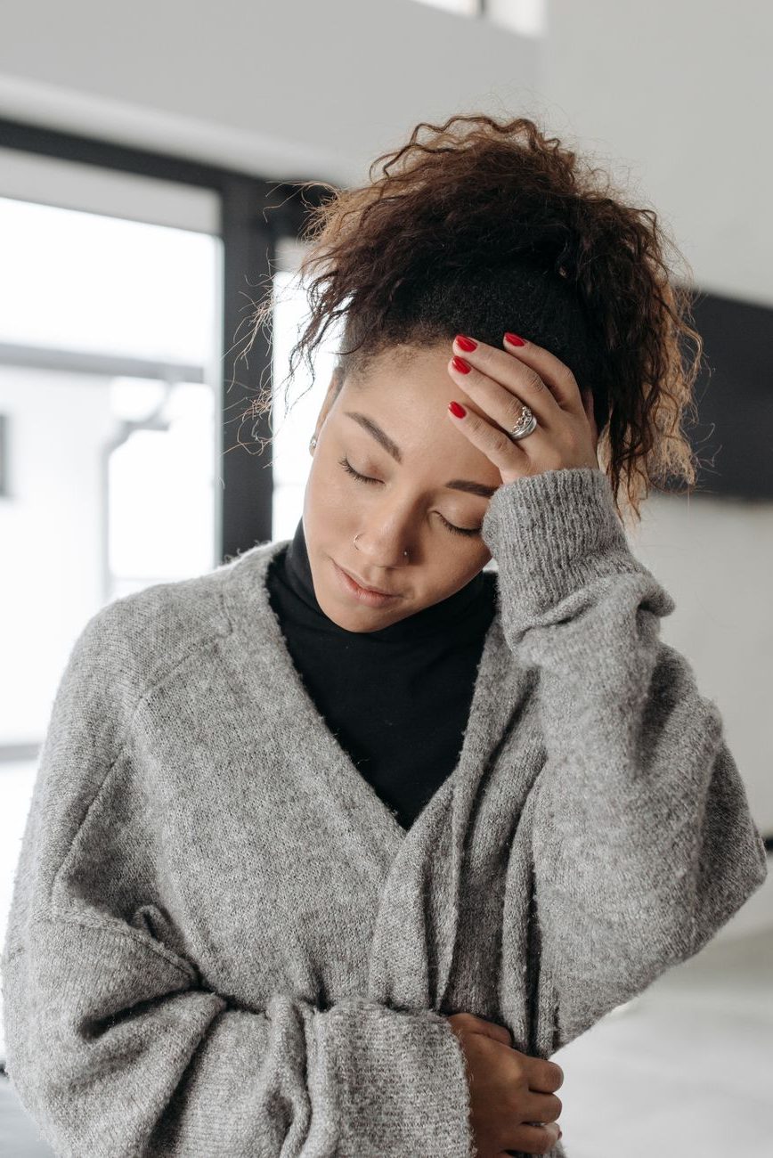 woman touching her forehead
